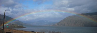 a rainbow arches across the Columbia River at Mosier, Oregon