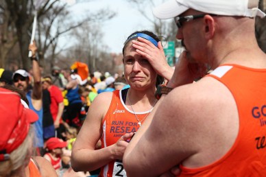 BOSTON, MA - APRIL 15:  A runner reacts near Kenmore Square after two bombs exploded during the 117th Boston Marathon on April 15, 2013 in Boston, Massachusetts. Two people are confirmed dead and at least 23 injured after two explosions went off near the finish line to the marathon.  (Photo by Alex Trautwig/Getty Images)