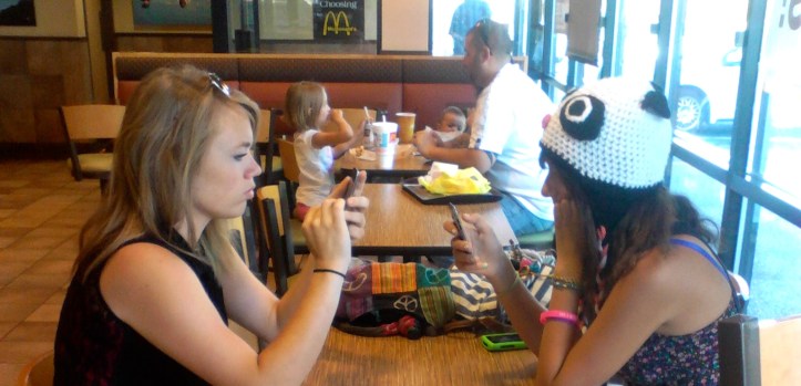 A young family and teen girls find a place to connect. Photo by Tim Graves
