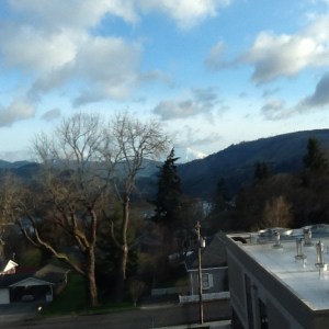 Mt. Adams emerges from behind the clouds on day six of my hospitalization.  The view is through the window of Providence Hood River Memorial Hospital. Photo taken with my iPad.