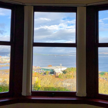 A window in three parts looks out over The Clyde and Greenock, Scotland.